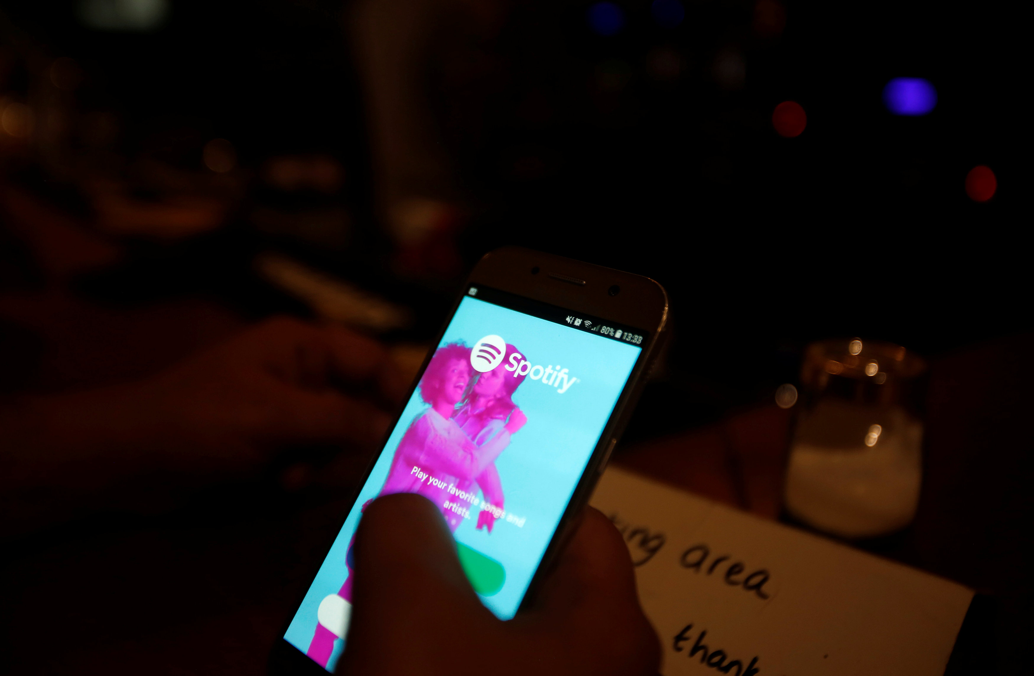 Palestinian musician Firas Harb uses Spotify app on his mobile phone in Beit Sahour, in the occupied West Bank.