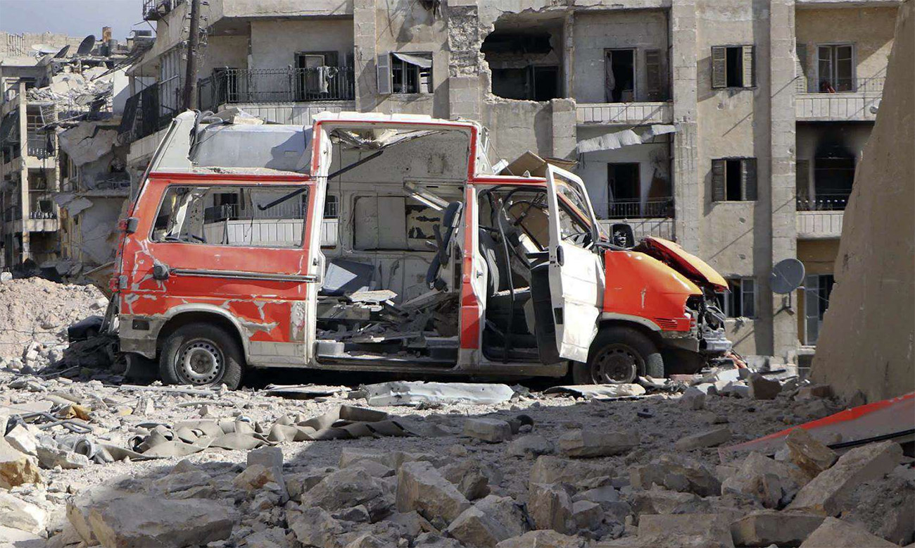 A destroyed ambulance is seen outside the Syrian Civil Defense main center after airstrikes in eastern Aleppo