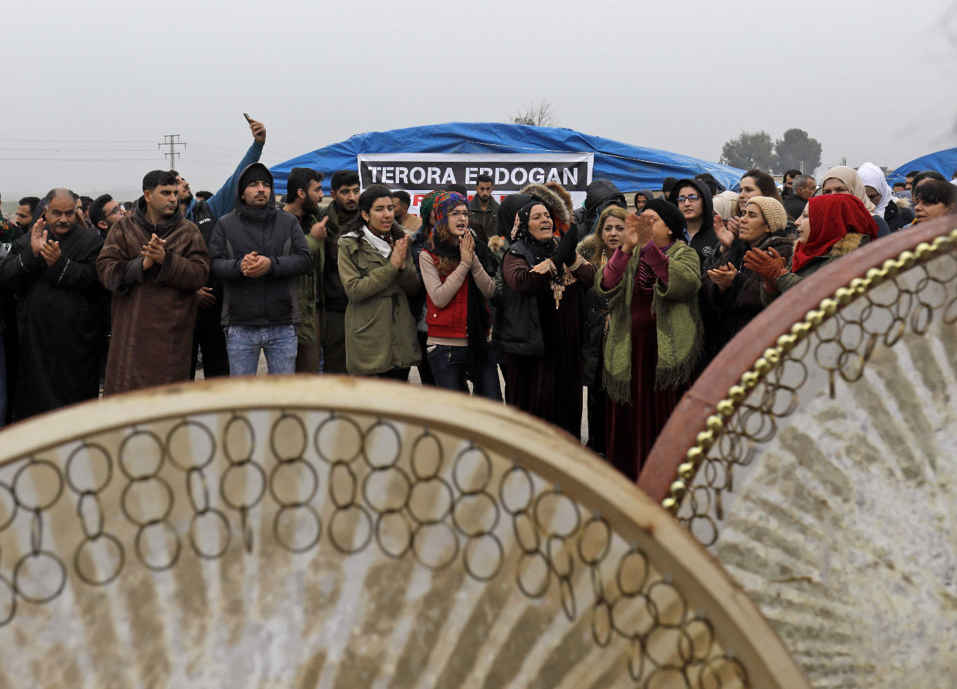 Kurdish demonstrators gather to protest near the border wall separating Turkey from Syria in the western Syrian countryside of Ras al-Ain on December 20, 2018.