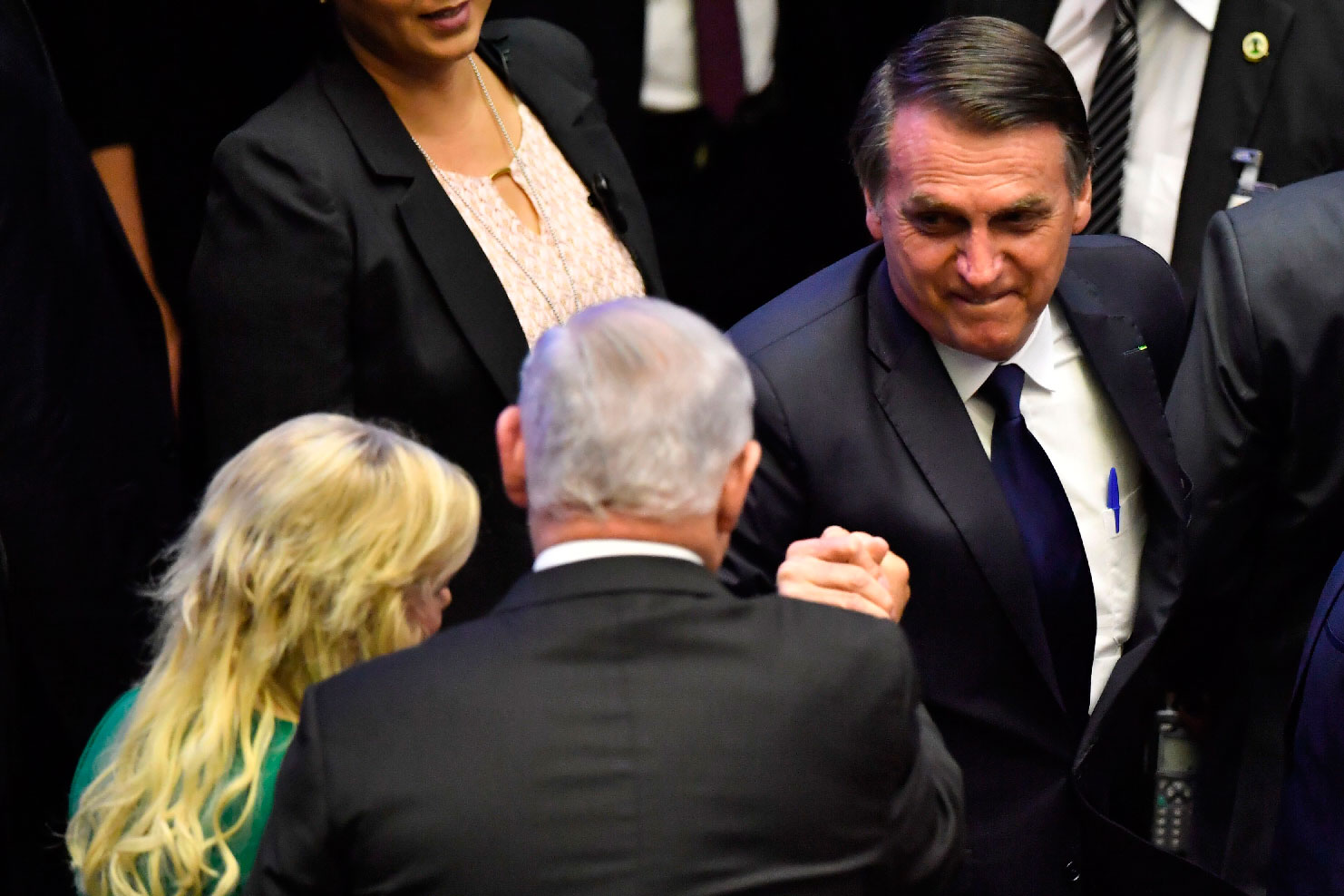 Brazil's newly sworn-in President Jair Bolsonaro (R) greets Israel's Prime Minister Benjamin Netanyahu (C), during his inauguration ceremony, at the Congress in Brasilia on January 1, 2019.