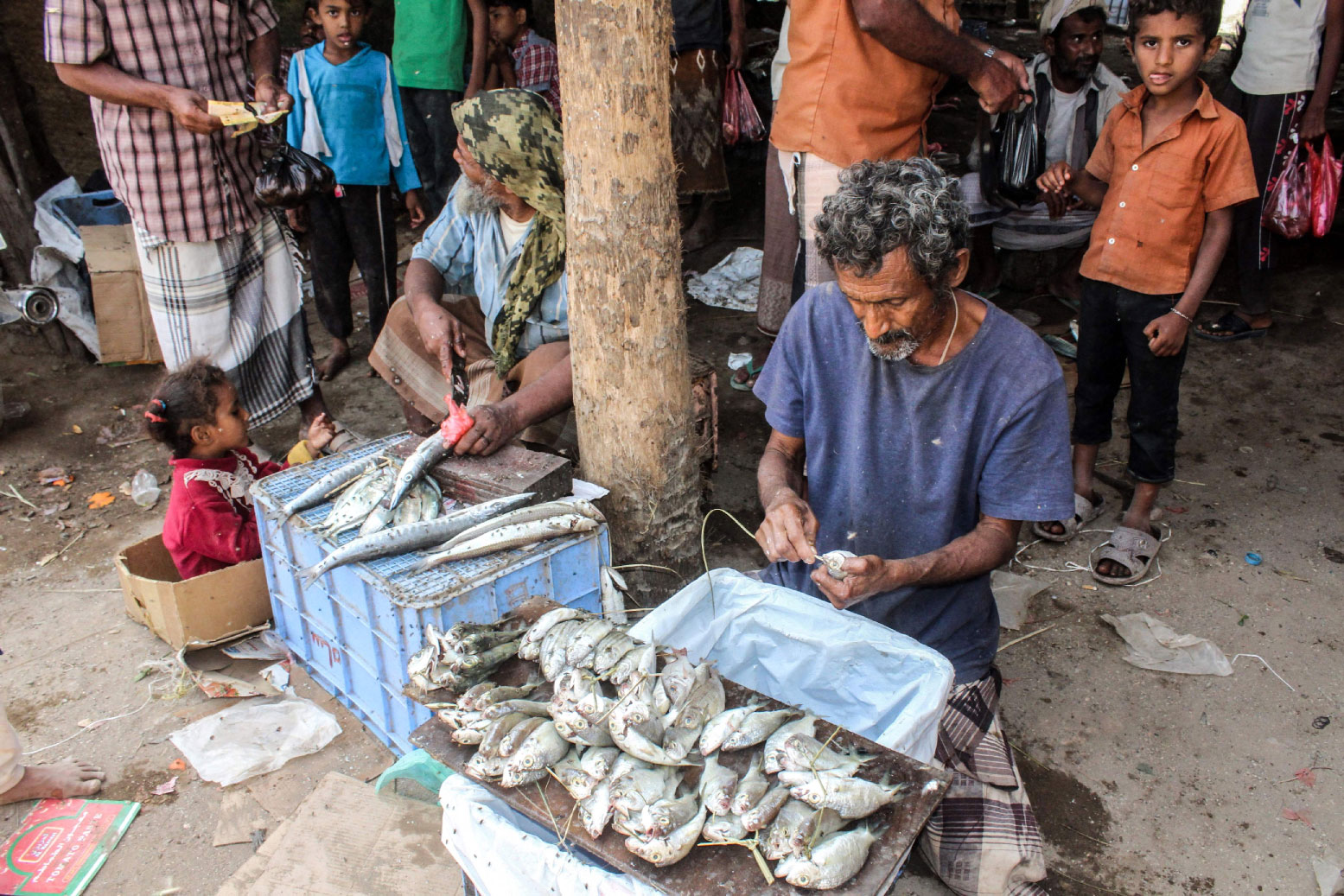 Yemeni fishermen clean and sell their catch at a market in the Khokha district of the western province of Hodeidah, on January 22, 2019.