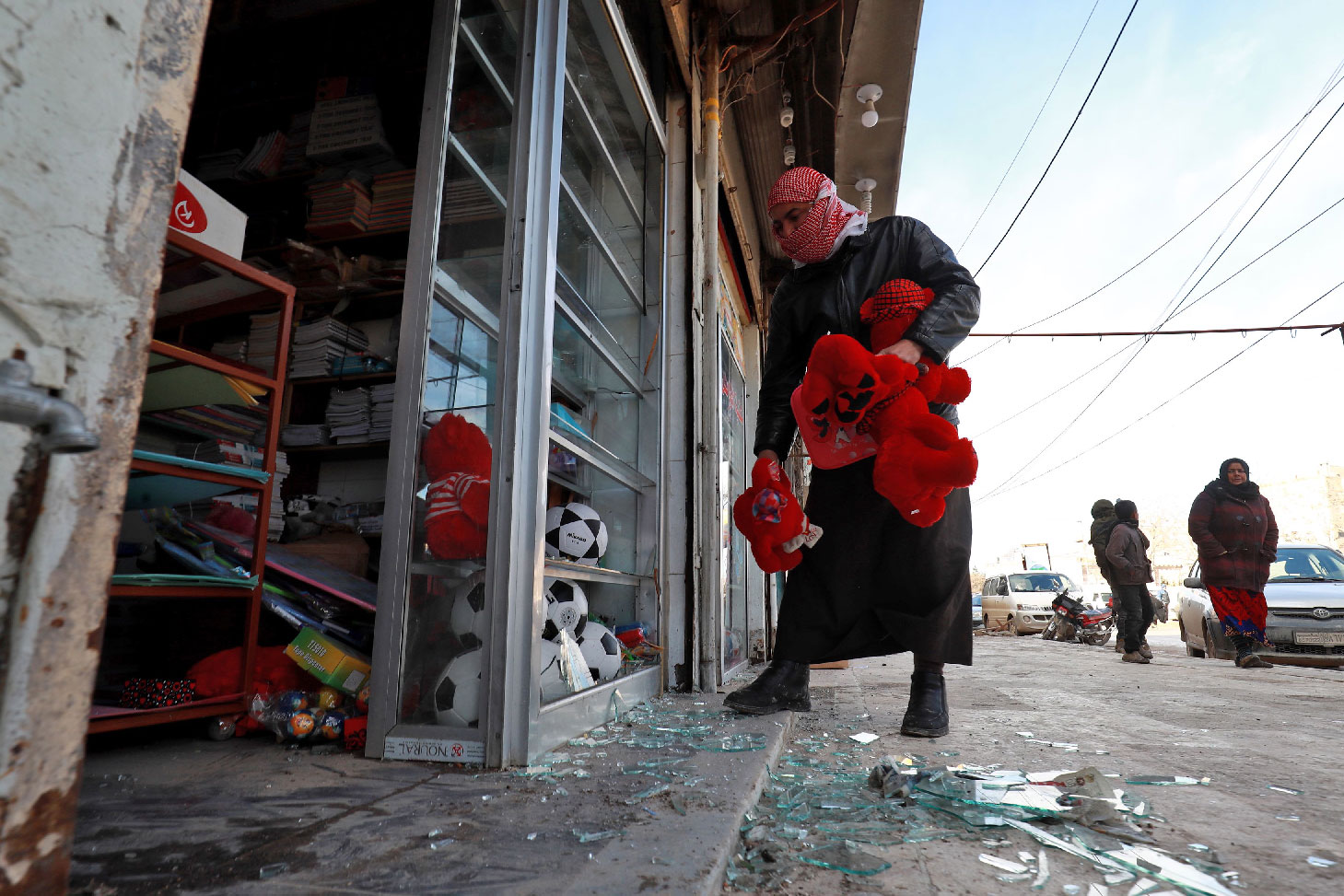 Syrians check the site of a suicide attack targeting US-led coalition forces in the flashpoint northern Syrian city of Manbij which killed four US serviceman the previous day on January 17, 2019.