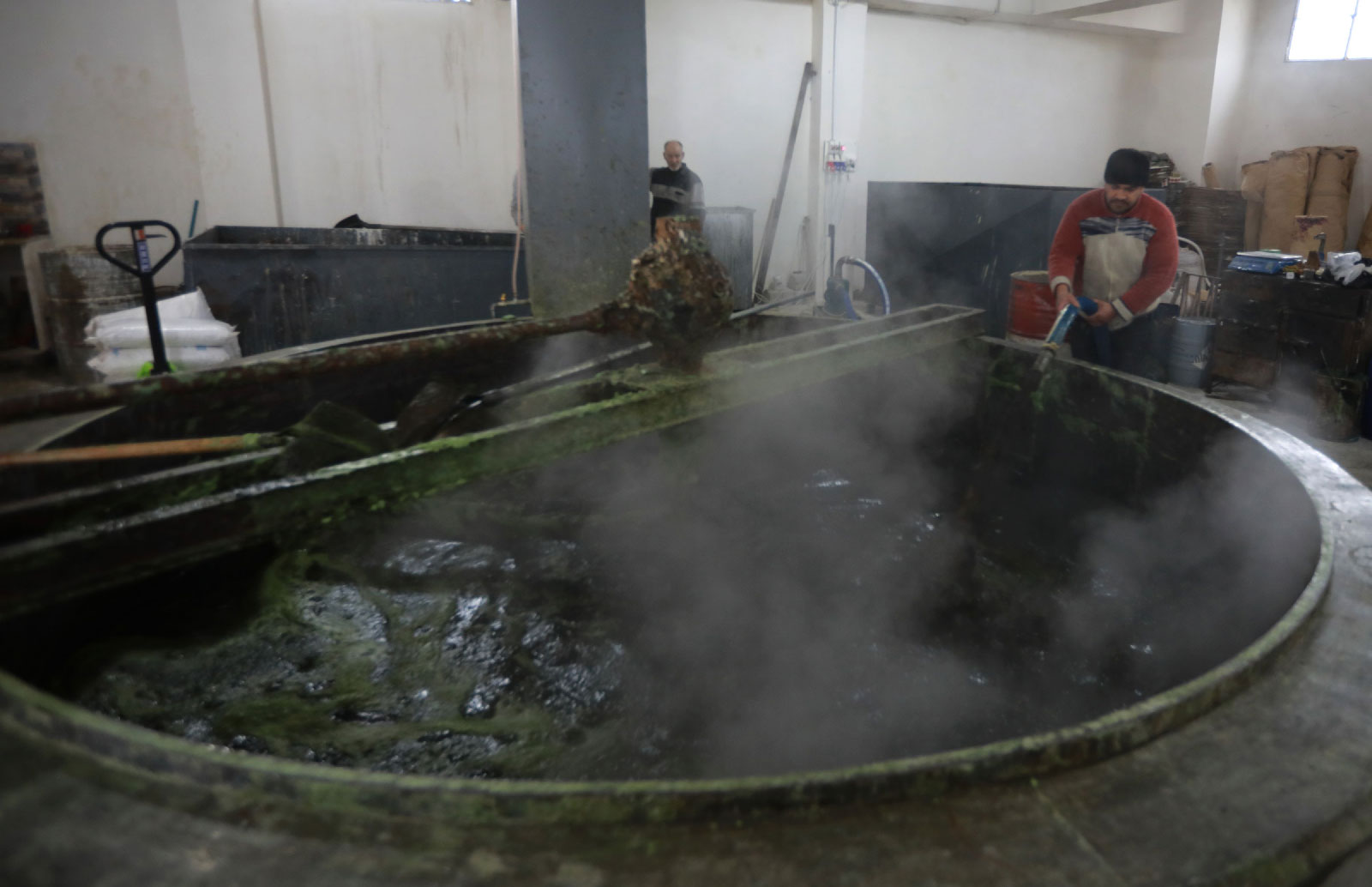 Syrian workers make olive soap in a factory on the outskirts of Aleppo on February 10, 2019.