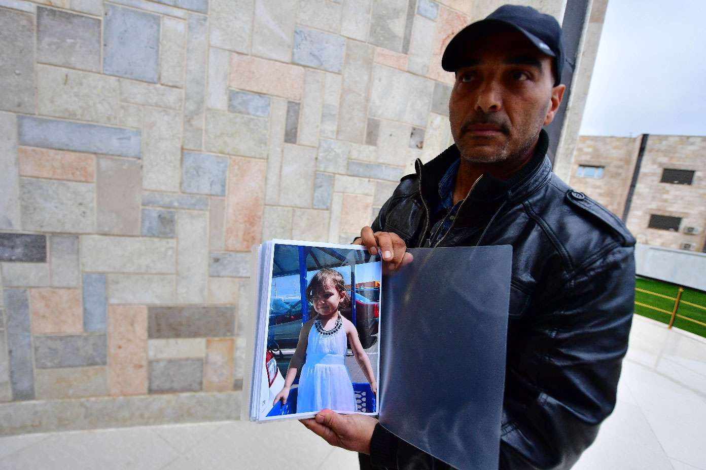 French-Moroccan Mustafa Tarbouni, the maternal uncle of a missing French girl, displays a picture of his niece as he tries to find her in Syria, on March 25, 2019 in the northern town of Qamishli.