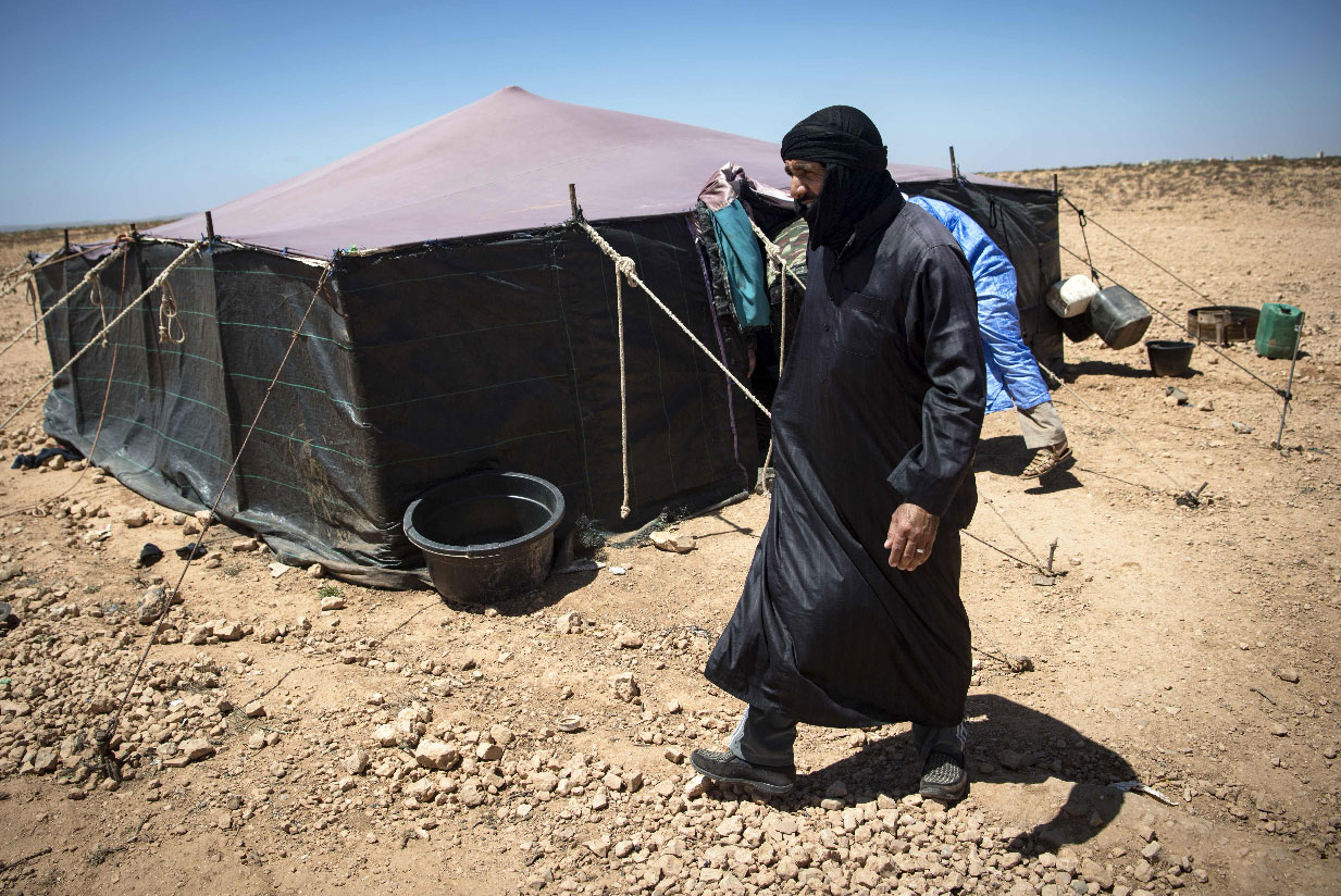 A Nomadic herder walks near tents in the southern Moroccan Tiznit province in the region of Souss-Massa