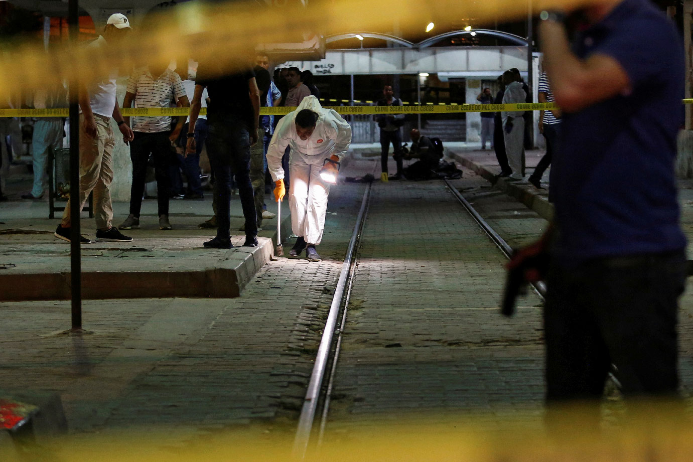 Authorities inspect the scene after a man reported to be wearing an explosive belt died in the Intilaka area in Tunis