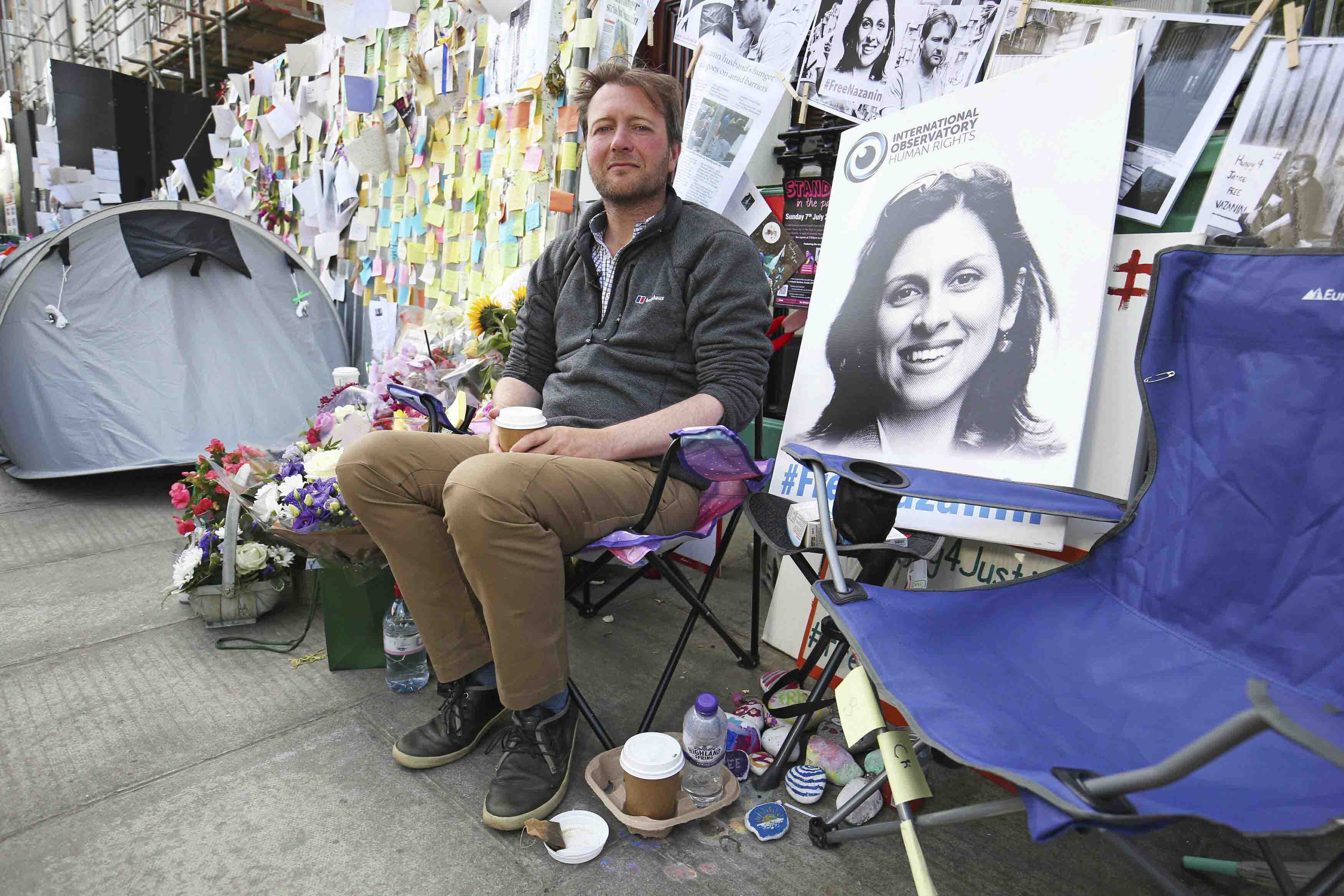 Richard Ratcliffe, the husband of detained Nazanin Zaghari Ratcliffe, with flower tributes and messages outside the Iranian Embassy in London