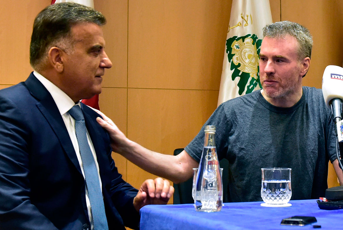 Kristian Lee Baxter (R) pats the shoulder of Lebanese security chief Abbas Ibrahim (L)
