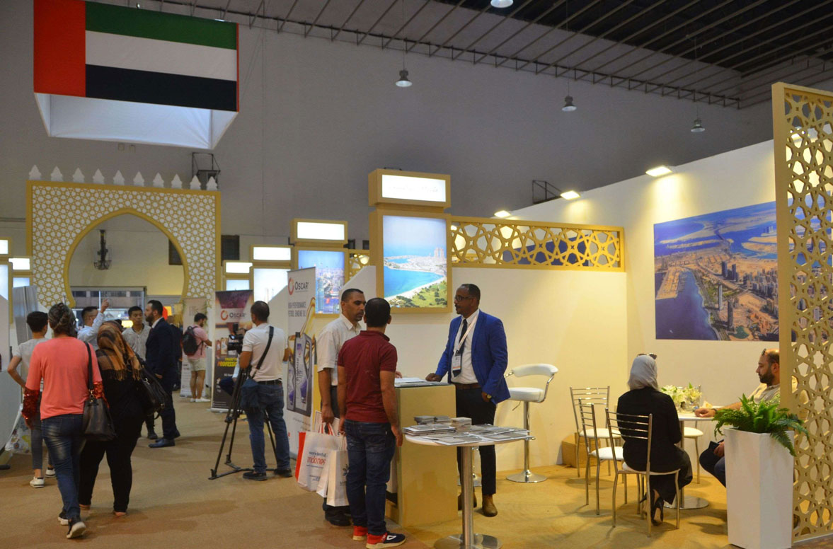 People inspect the stall of Emirati companies at the Damascus Fair in the Syrian capital