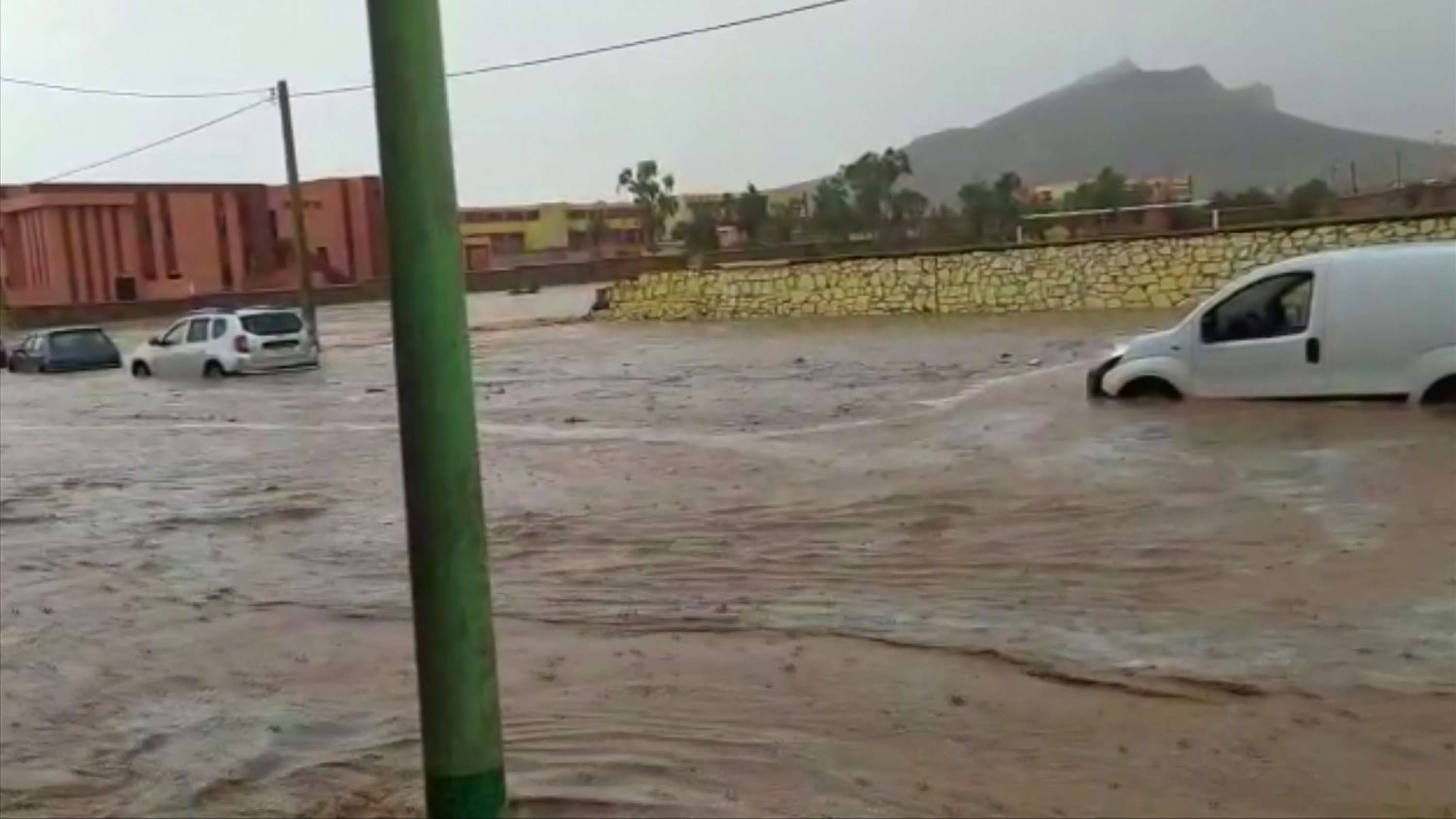 Photographs and videos shared on social media showed muddy waters carrying away people