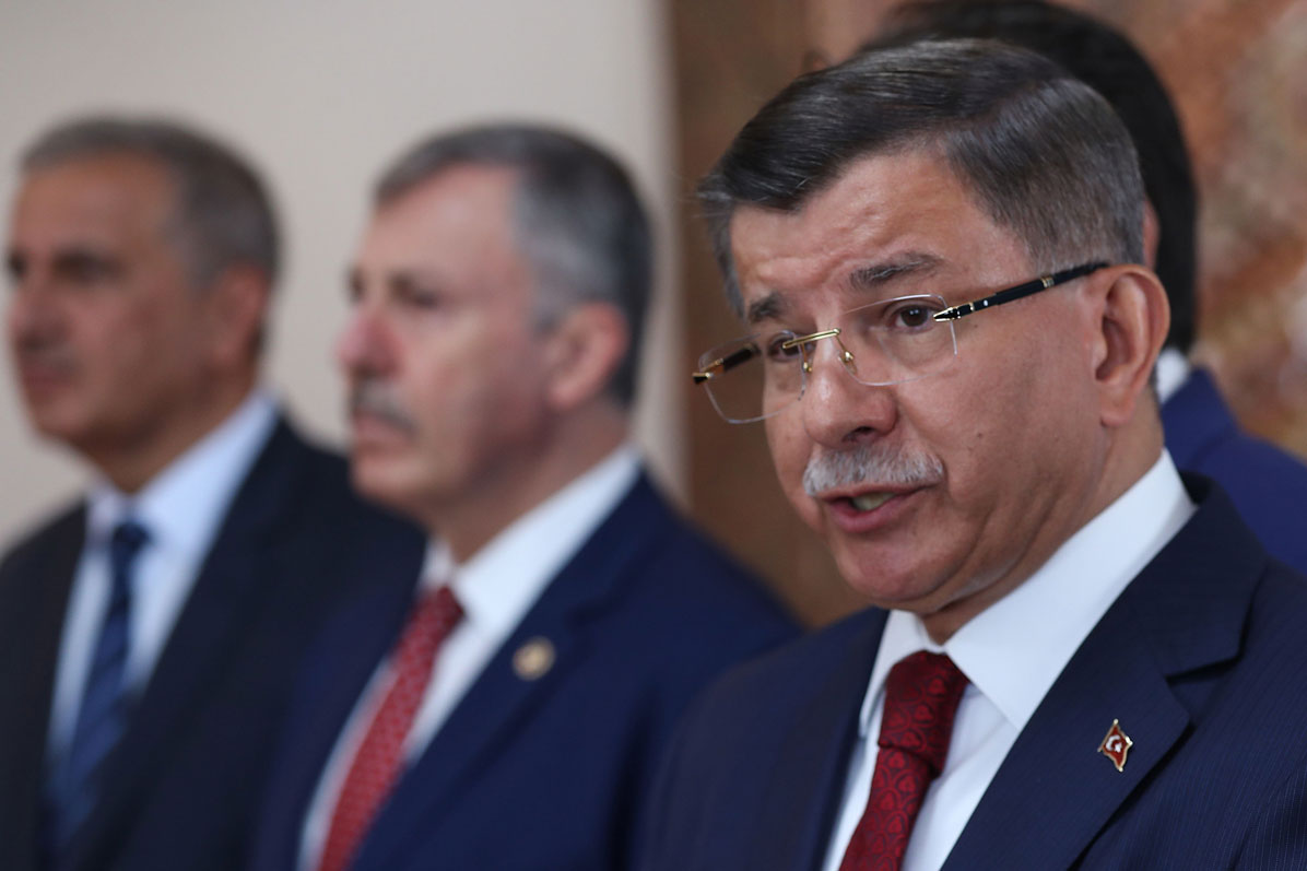 Former Turkish Prime Minister Ahmet Davutoglu (R) holds a press conference at his home in Ankara