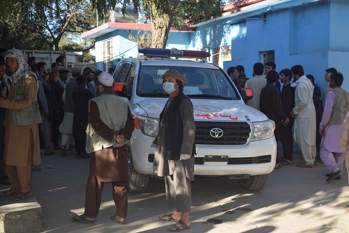 Relatives of Afghan victims arrive outside a hospital, after a suicide attack that targeted a campaign rally for Afghan President Ashraf Ghani