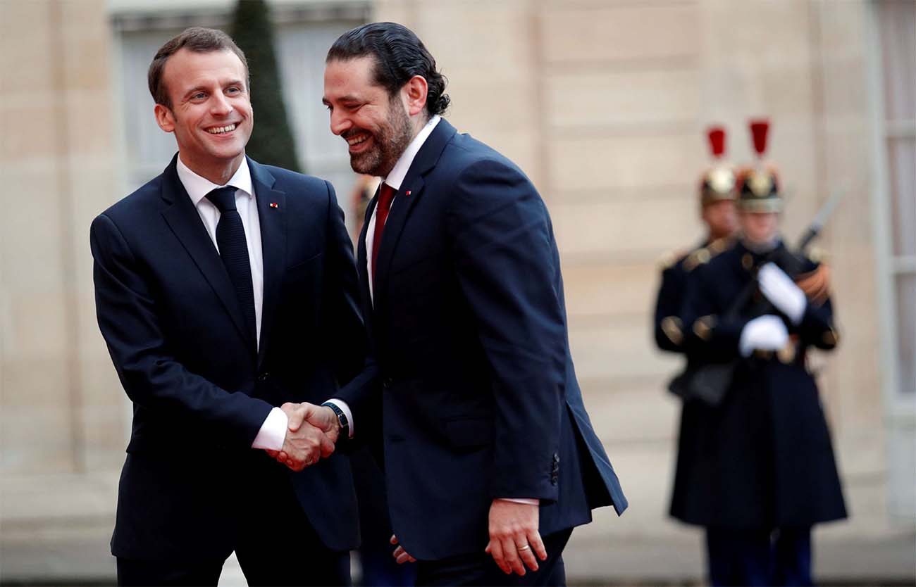 French President Emmanuel Macron welcomes Lebanese PM Saad al-Hariri as he arrives at the Elysee Palace last year