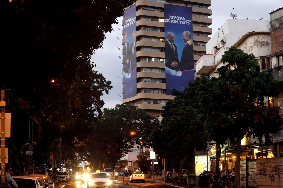 Giant banners of Netanyahu shaking hands with Putin and Trump hung on the Likud's party headquarters