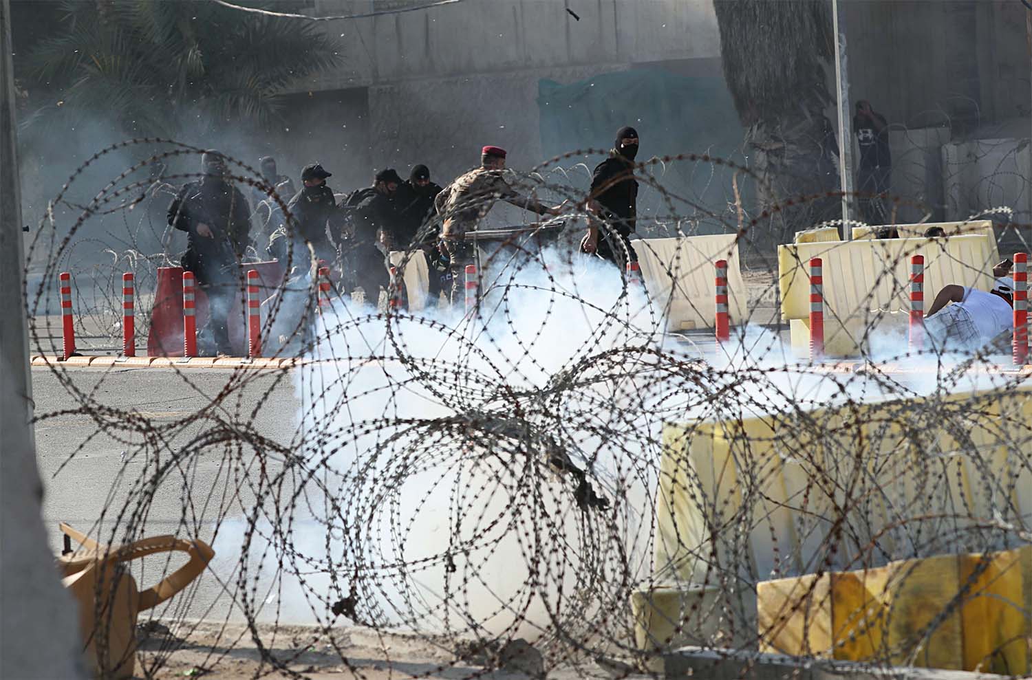 Iraqi security forces fire tear gas to disperse anti-government protesters during a demonstration in central Baghdad,