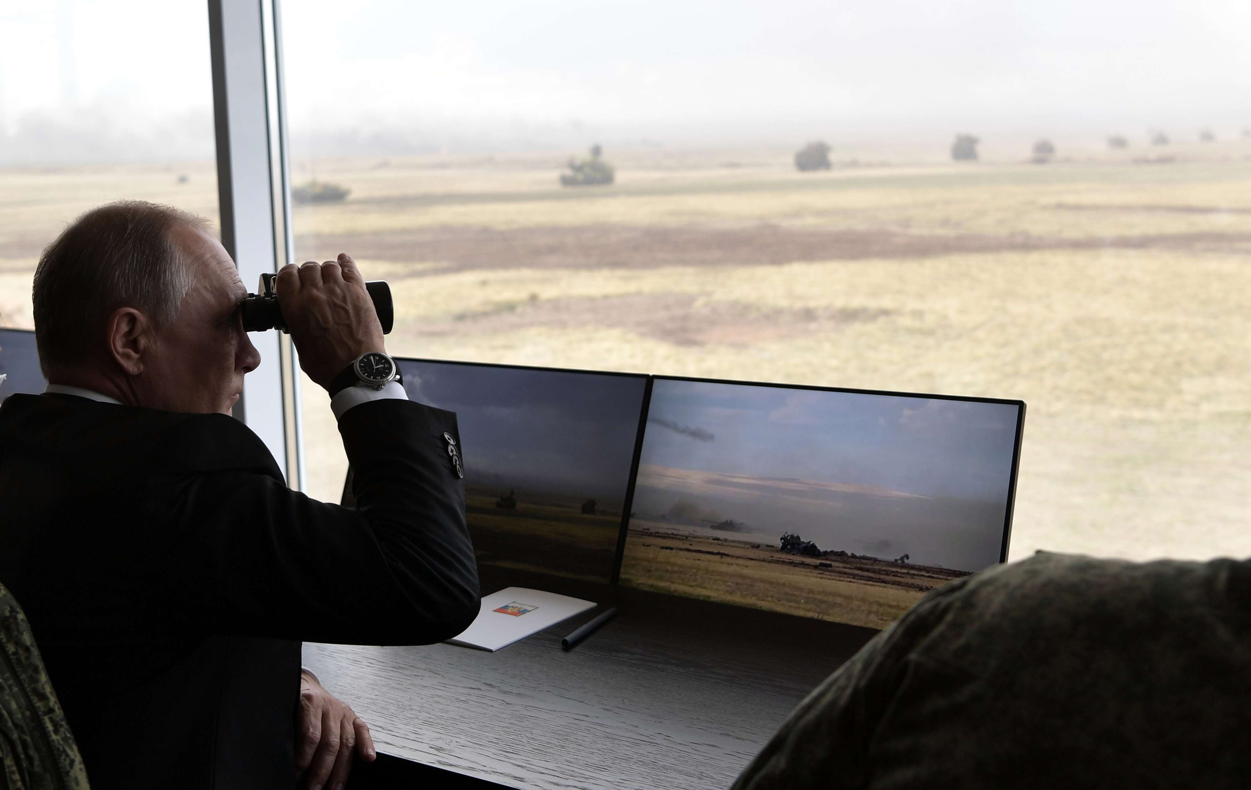 Photo taken on Friday, Sept. 20, 2019, Russian President Vladimir Putin holds binoculars while watching the military exercises Center-2019 at Donguz shooting range near Orenburg, Russia