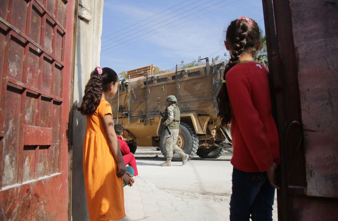 Turkish soldiers patrol the northern Syrian town of Tal Abyad on the border between Syria and Turkey