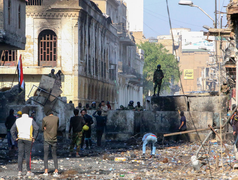 Iraqi demonstrators rally in Al-Rashid Street near the central bank in the capital Baghdad