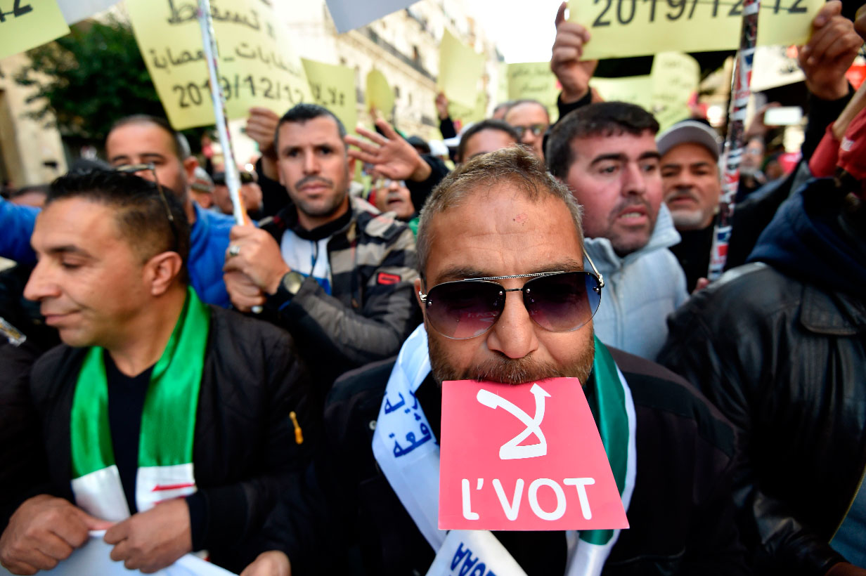 Algerians chant slogans as they march during an anti-government demonstration in the Algerian capital Algiers