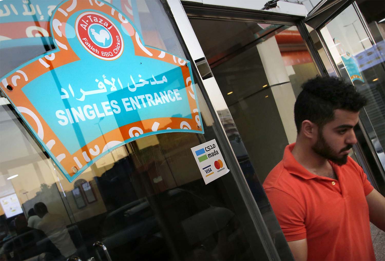 A man leaves the singles entrance at a restaurant in Jeddah