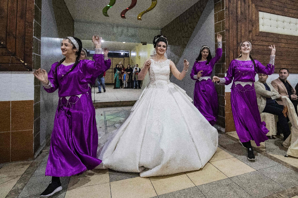 Luvin Yusuf, a Kurdish bride, arrives to her wedding ceremony in the Kurdish-majority city of Qamishli