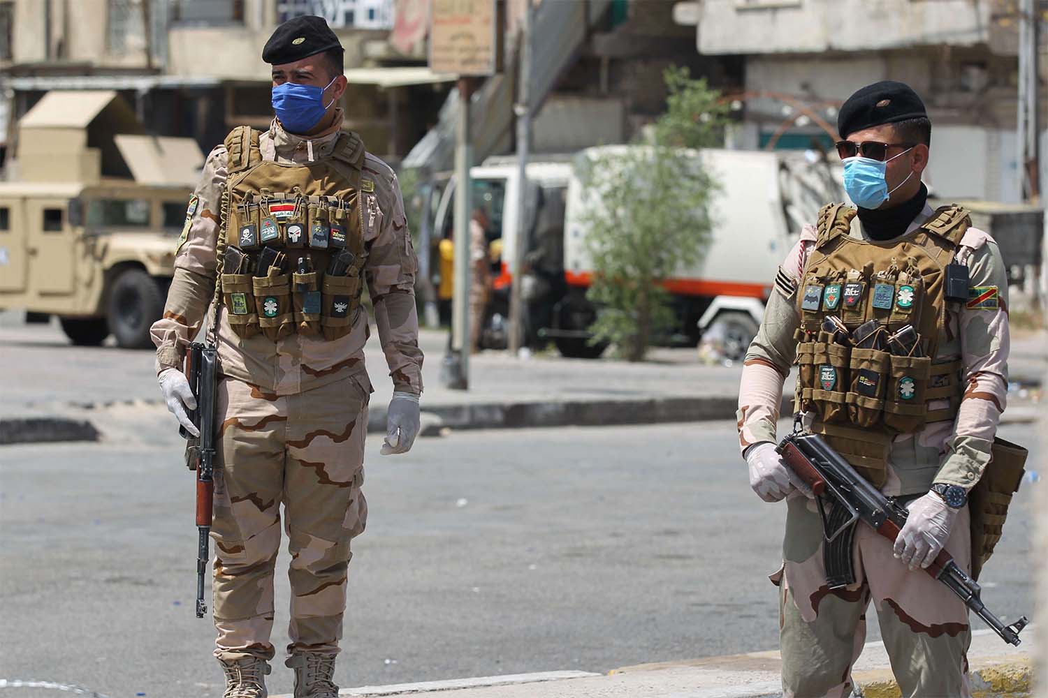Iraqi security forces stand guard at a checkpoint in Baghdad