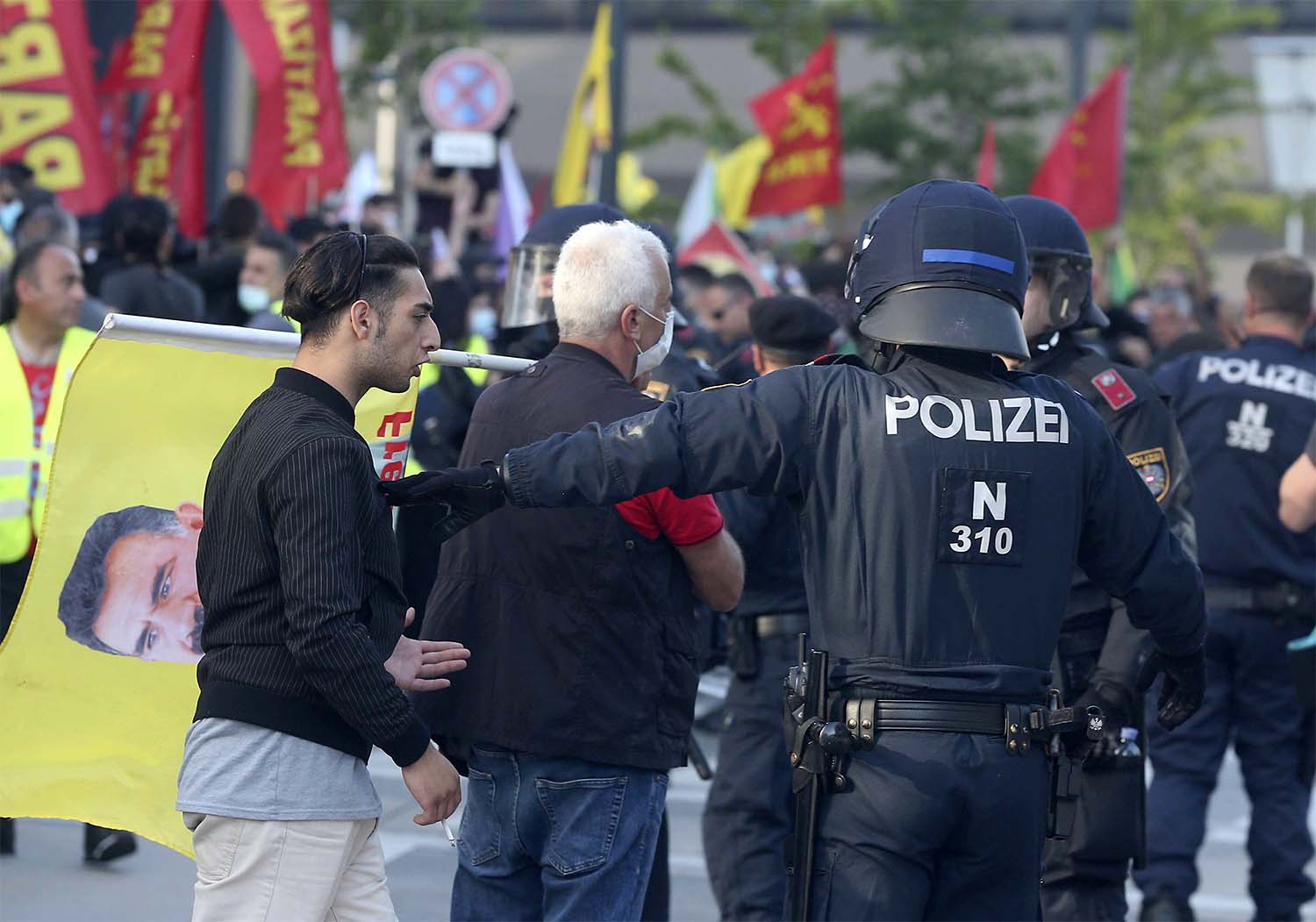 Police separate Kurdish and Turkish demonstrators during a demonstration by Kurdish protesters