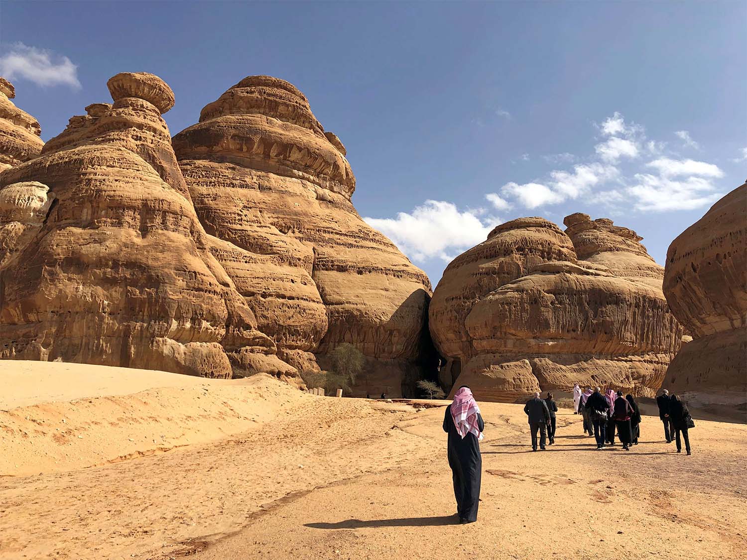 Visitors walk outside the tombs at the Madain Saleh antiquities site, al-Ula, Saudi Arabia