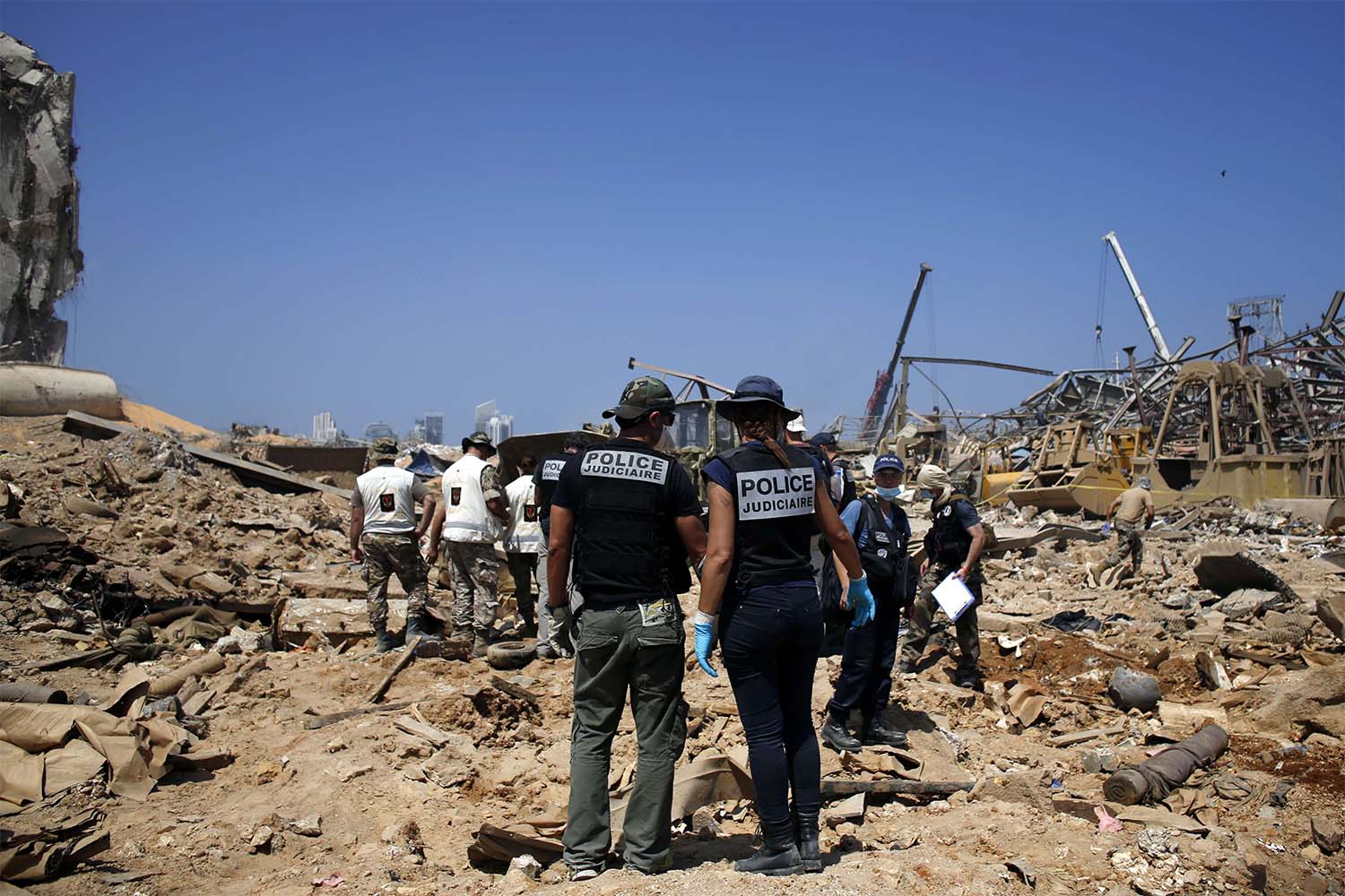 French criminal police officers work on the site of the massive explosion in the port of Beirut