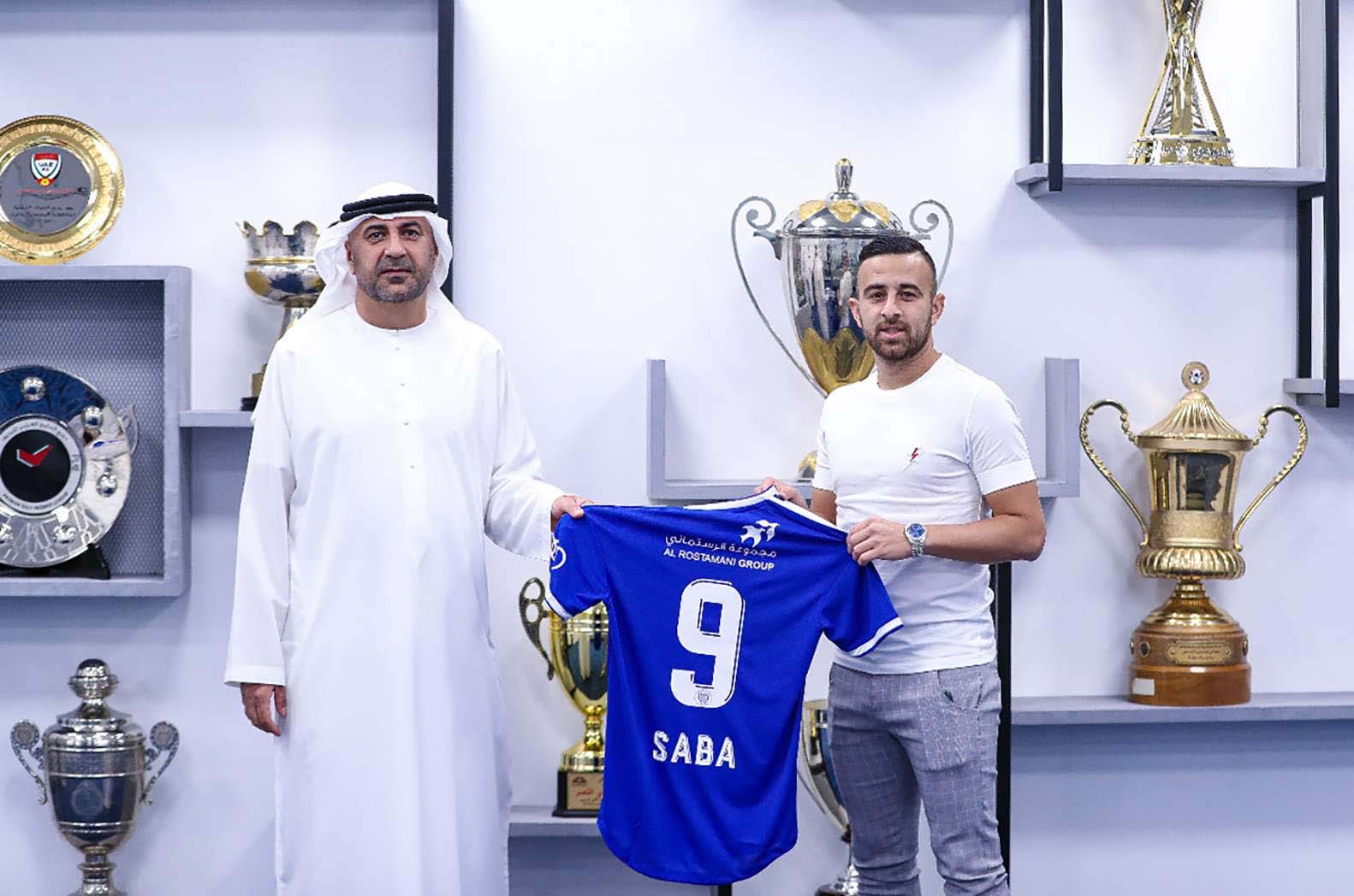 Dia Saba (R) posing with a club official during his official presentation at the club
