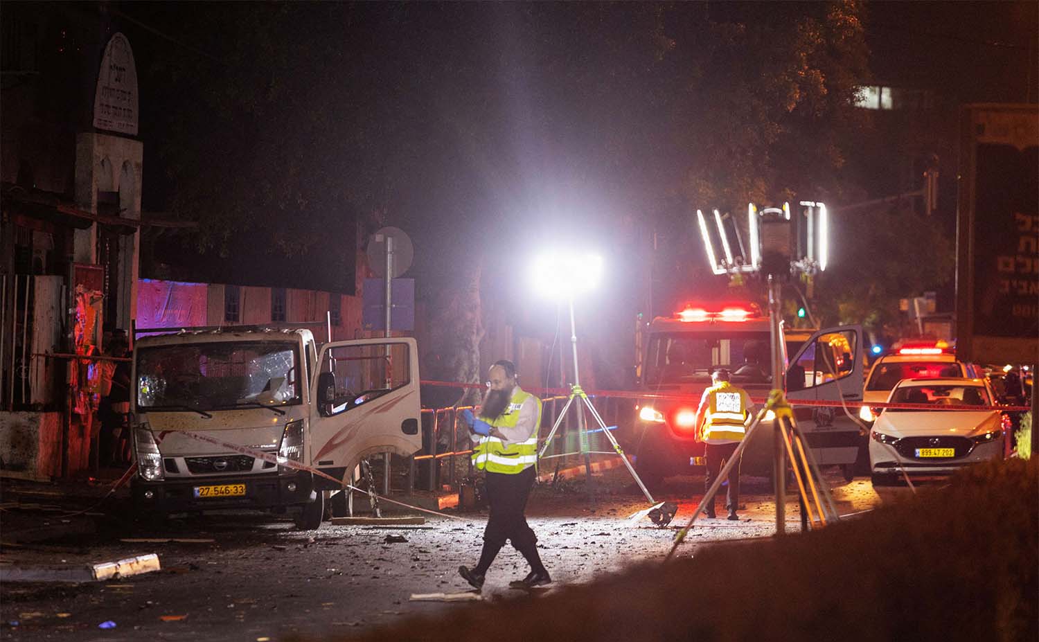 Israeli security and emergency responders work at the site of a bomb blast in Tel Aviv