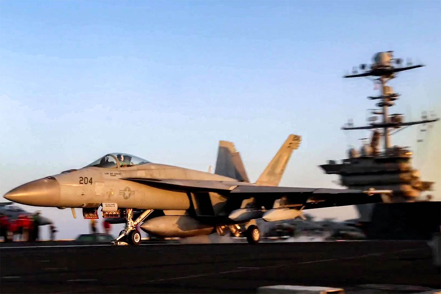 A US F/A-18 fighter aircraft taking off from an aircraft carrier at sea reportedly amidst operations launched against Houthis in Yemen