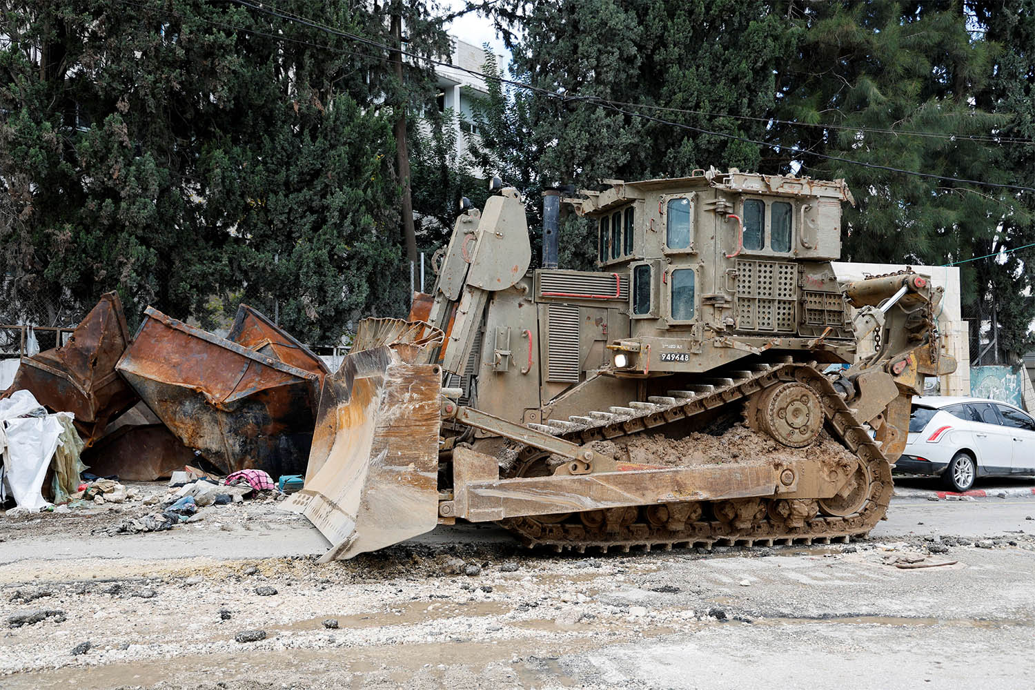 An armored caterpillar bulldozer stands on a street during an Israeli raid at Tulkarm