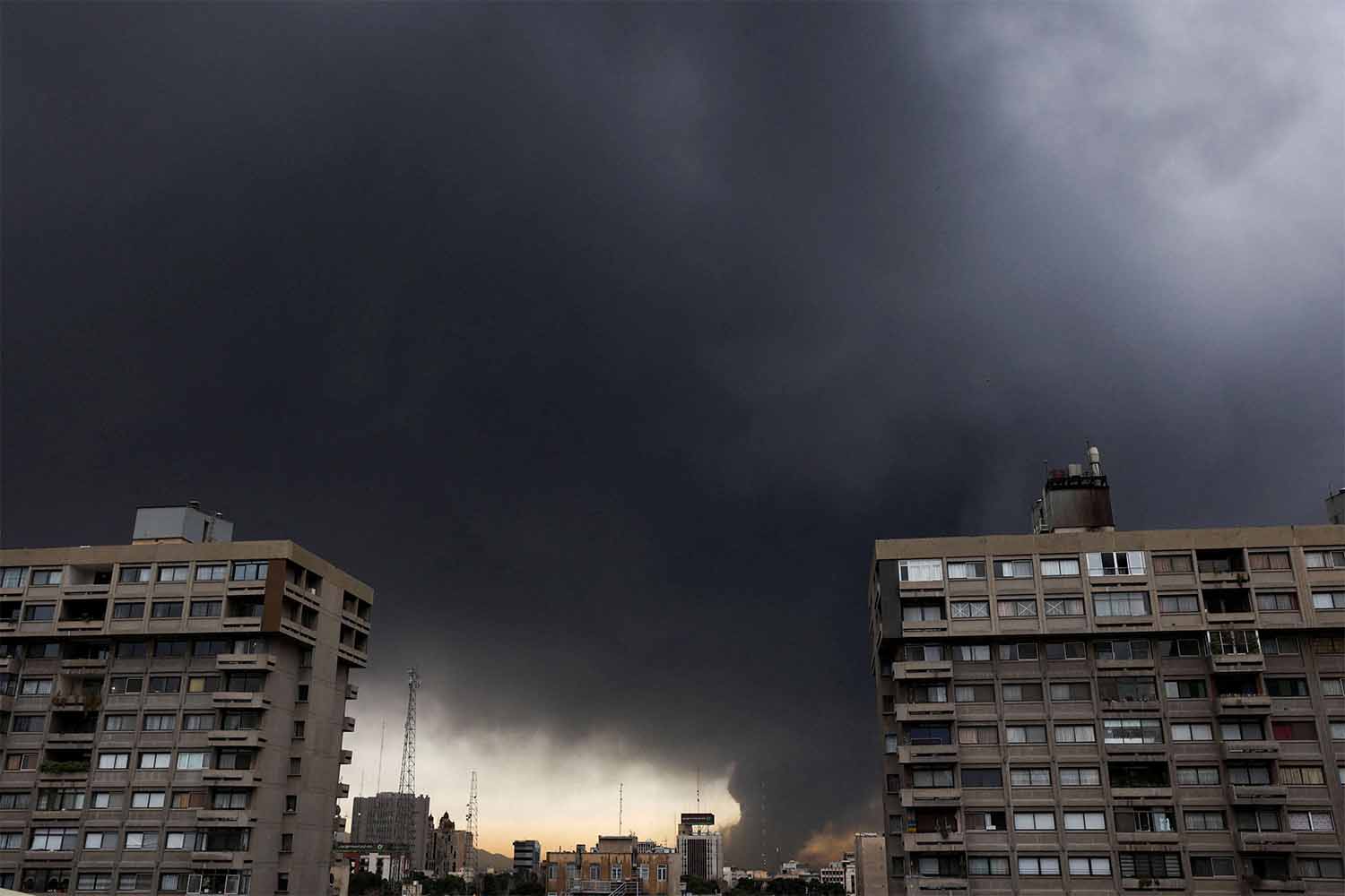 Smoke rises after a reported strike on fuel tanks at an oil refinery in Tehran