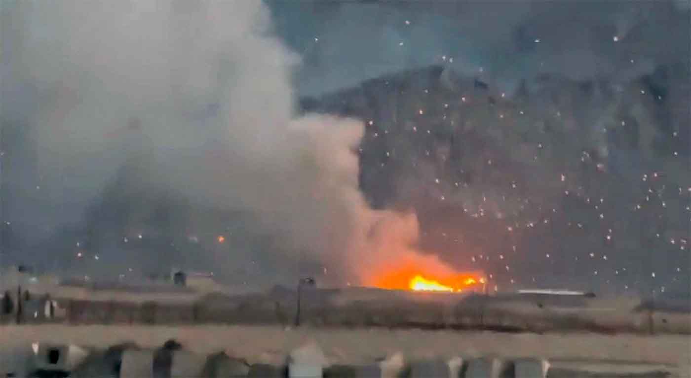 Burning debris litters the surrounding area, amid the US-Israeli conflict with Iran, in Baharestan, Isfahan province, Iran 