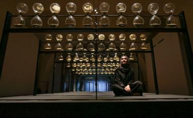 Co-designer Kholoud Sharafi poses inside the artwork entitled 'United Arab Emirates, Time is Subjective' by designers Reem Al Ghaith, Kholoud Sharafi, Carlos Gris, Hamza Al Omari, and Claudia Rivera