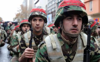 Members of Iran's paramilitary Basij militia parade in front of the former US embassy in Tehran, to mark the national Basij week