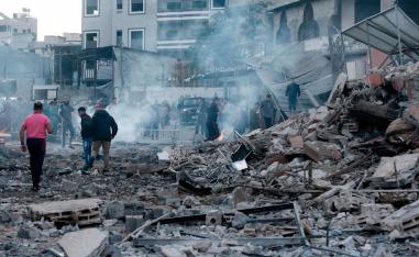 People inspect the rubble of a building following an Israeli air strike on Gaza City on October 27, 2018.