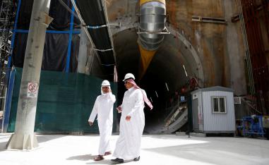 Men walk at the construction site of Riyadh Metro