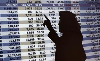 In this Oct. 7, 2008 file photo, the shadow of a Saudi trader is seen on a stock market monitor in Riyadh, Saudi Arabia