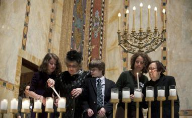 Holocaust survivors light symbolic candles at the Temple Emanu-El during the annual Holocaust Remembrance Day in New York