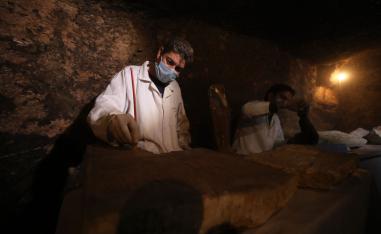 gyptian archaeologists work inside a tomb in the Saqqara necropolis.