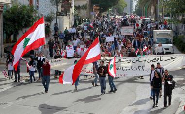 Protesters hold banners and Lebanese flags in Beirut
