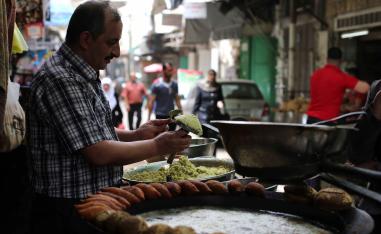 More than what’s on a plate. A Palestinian man makes falafel, a traditional dish consisting of fried chickpeas, on a street in Nablus