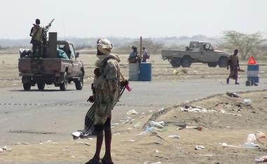 Yemeni pro-government forces gather at a checkpoint in a street on the eastern outskirts of Hodeidah.