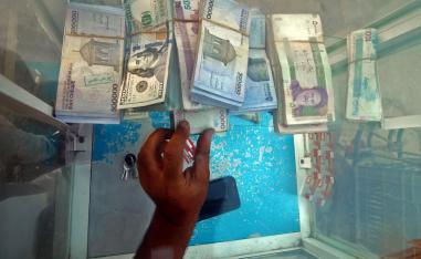 US dollars and Iranian rials at a change desk in Basra on November 6, 2018.