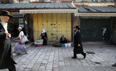 People walk past closed shops during a general strike in Jerusalem's Old City
