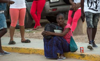A Sub-Saharan migrant sits as she waits to leave the temporary centre for immigrants and asylum seekers in the Spanish enclave of Melilla on September 19 , 2018.