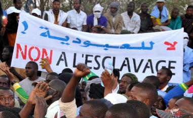People holding a banner reading "No to slavery" during a demonstration against discrimination in Nouakchott, Mauritania.