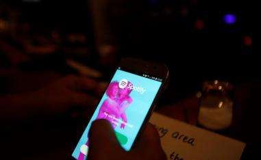 Palestinian musician Firas Harb uses Spotify app on his mobile phone in Beit Sahour, in the occupied West Bank.